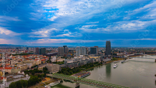 Fotografie Sky over a city with river and buildings