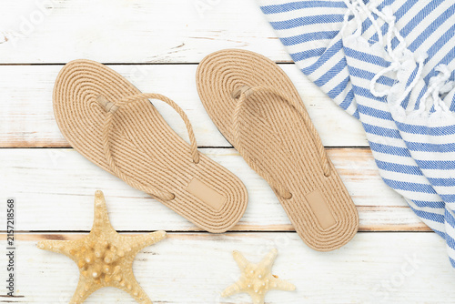 Summer vacation accessories on wooden background, top view