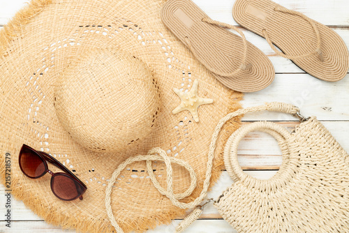 Summer vacation accessories on wooden background, top view