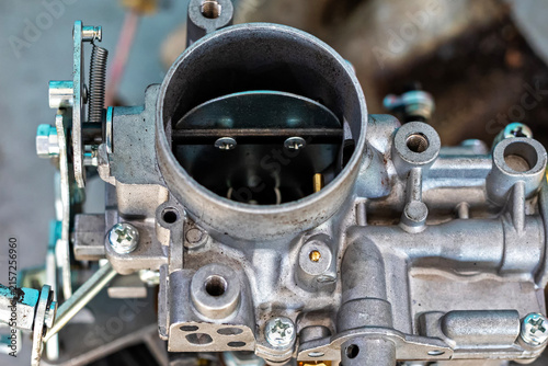 View of the carburetor throttle valve. A carburetor (also spelled carburettor or carburetter) is a device used by a gasoline internal combustion engine to control and mix air and fuel entering.