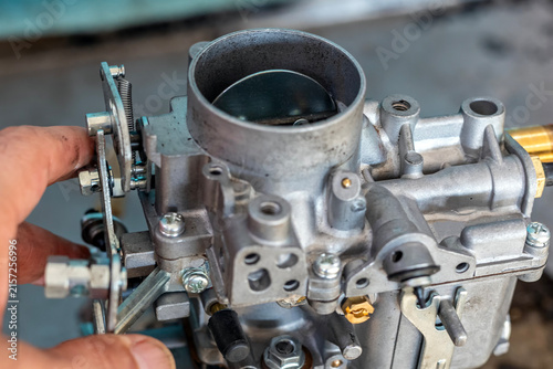 View of the carburetor throttle valve. A carburetor (also spelled carburettor or carburetter) is a device used by a gasoline internal combustion engine to control and mix air and fuel entering.