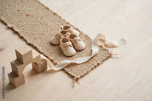 Handmade Baby Booties on Rustic Woven Mat