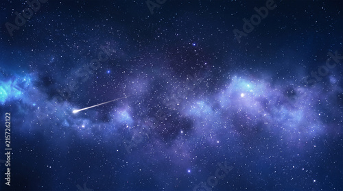 A bright shooting star streaking across a deep blue starry night sky