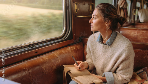 Woman on a slow train journey across Europe enjoying a peaceful mini retirement travel break