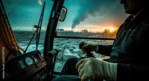 Construction Operator At Work In A Rainy Industrial Setting With Sunset