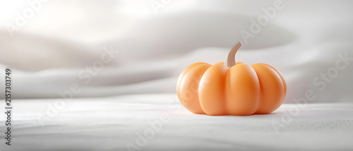 Small pumpkin on a white surface.