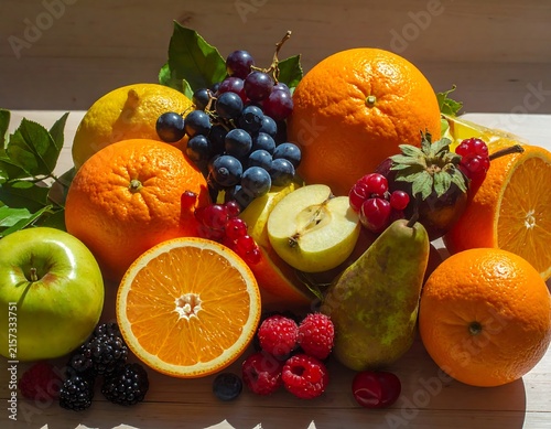 Fresh citrus fruits and berries arrangement on table.