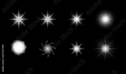 A collection of various white glowing star shapes and abstract light effect elements isolated on a black background