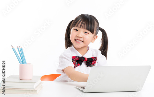 Картината върху платно Diligent Asian schoolgirl writing in notebook and smiling at camera, primary education