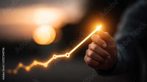 Hand holding glowing upward rising financial graph symbol of investment and market growth