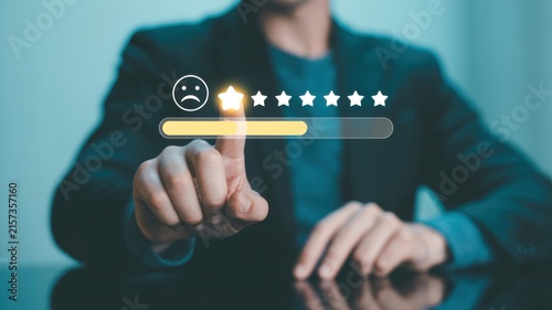 Businessman touching digital satisfaction rating interface with one star rating