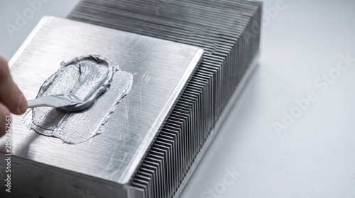 фотографія Applying thermal paste to a computer CPU heatsink for efficient heat dissipation and cooling