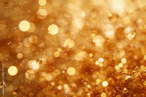 Abstract warm golden bokeh background with countless soft glowing circles of light creating a magical festive atmosphere perfect for holiday overlays and text.