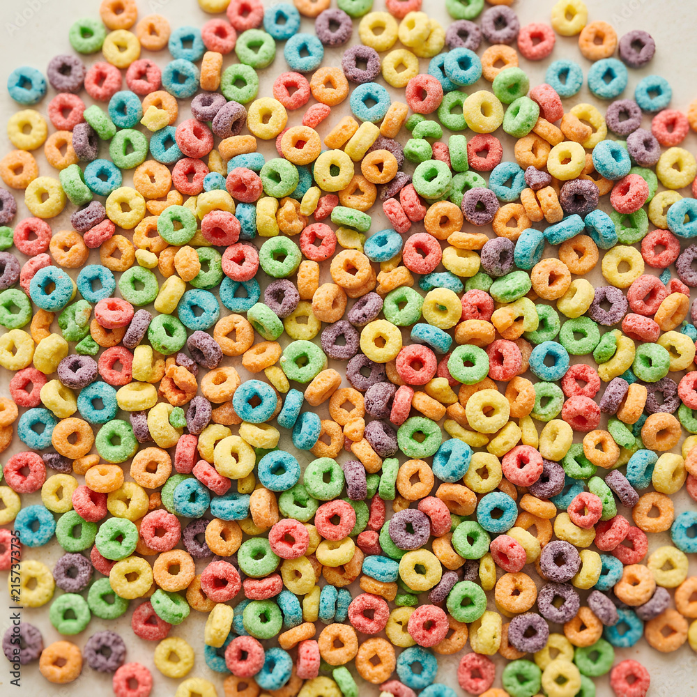 Fototapeta premium Colorful fruity loop cereal rings flat lay background.