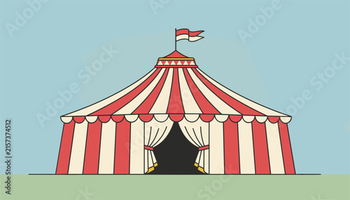 Classic red and white striped circus big top tent with an open entrance under a blue sky and on green grass.