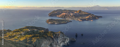 Aerial view of the volcanic Aeolian Islands, including Vulcano and Lipari, surrounded by the Tyrrhenian Sea under golden hour light in Lipari, Sicily, Italy.