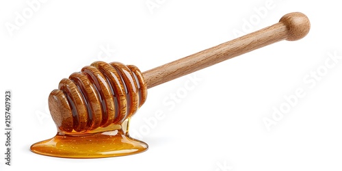 A wooden honey dipper coated in amber honey rests against a white background