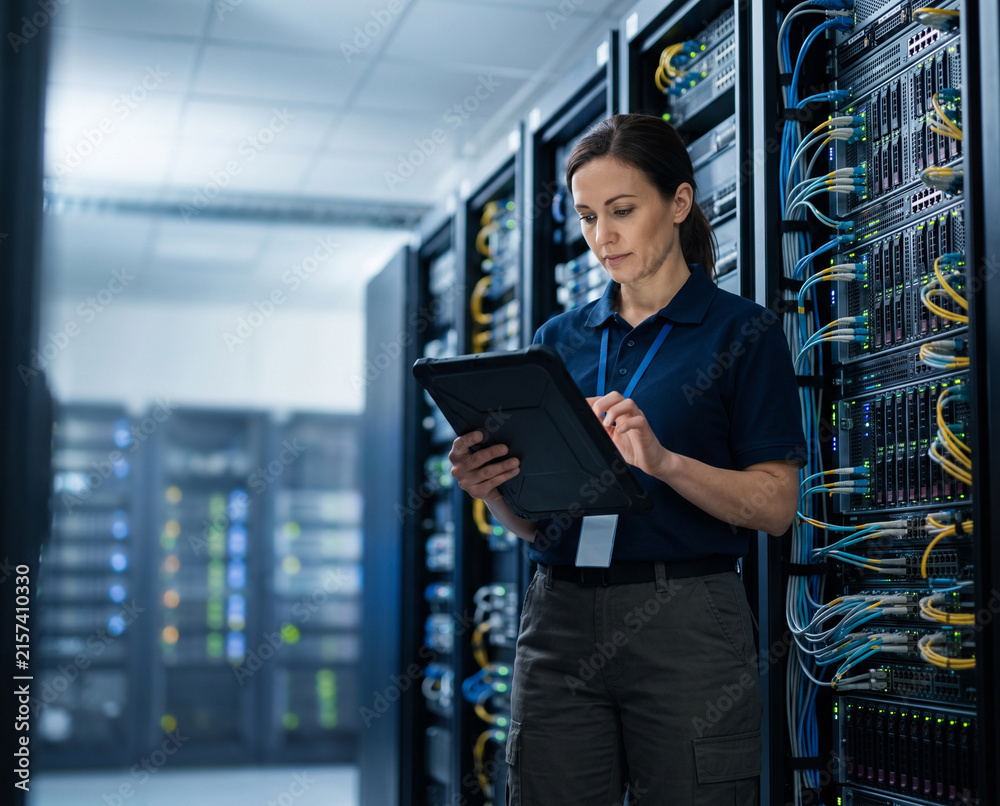 Fototapeta premium Data center engineer inspects enterprise server racks with digital tablet, supporting infrastructure monitoring, server maintenance, network management, cloud computing and reliable IT operations with