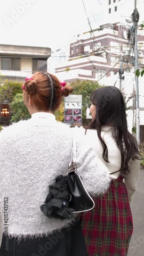 Young Women Walking Through Harajuku Street in Tokyo Japan