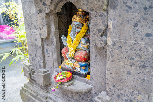Konstfotografi Colorful Ganesha statue with yellow marigold garland in a volcanic stone shrine