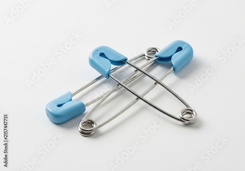 Three Blue Baby Safety Pins Isolated on White Background - Diaper Fasteners for Newborn Boy Care and Sewing Projects