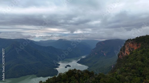 An aerial video showing the forest, mountains, and river in the morning.
