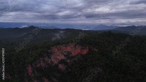 An aerial video showing the forest, mountains, and river in the morning.