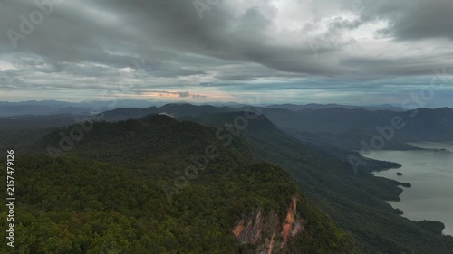 An aerial video showing the forest, mountains, and river in the morning.