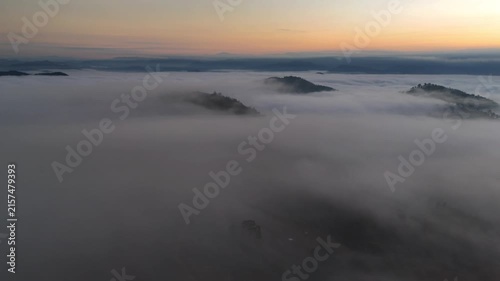 An aerial video showing misty mountains in the morning as the sun rises.