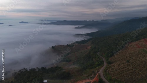 An aerial video showing misty mountains in the morning as the sun rises.