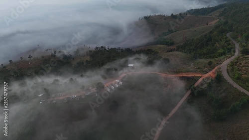 An aerial video showing misty mountains in the morning as the sun rises.