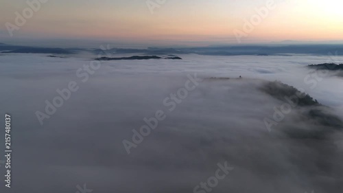An aerial video showing misty mountains in the morning as the sun rises.