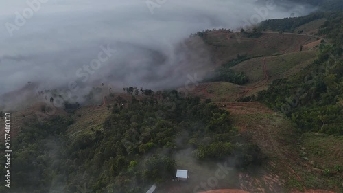 An aerial video showing misty mountains in the morning as the sun rises.