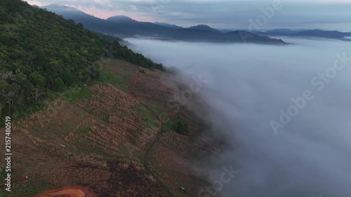 An aerial video showing misty mountains in the morning as the sun rises.