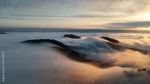 An aerial video showing misty mountains in the morning as the sun rises.