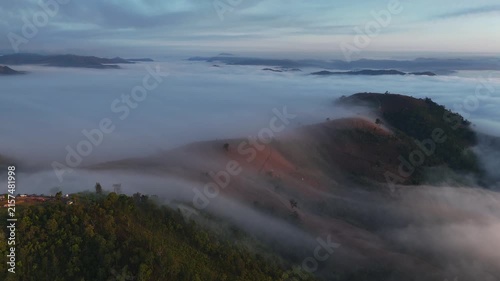 An aerial video showing misty mountains in the morning as the sun rises.