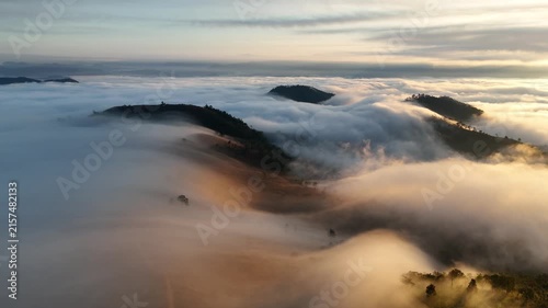 An aerial video showing misty mountains in the morning as the sun rises.