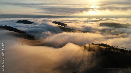 An aerial video showing misty mountains in the morning as the sun rises.