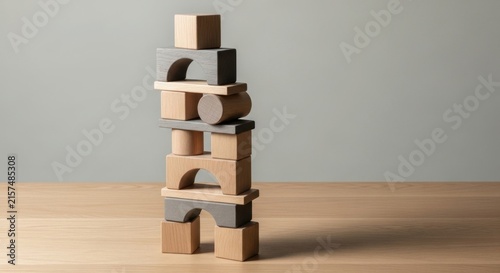 Wooden blocks stacked in a precarious tower on a table.