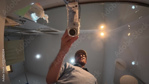 Low-angle view of a man washing his hands, filmed from inside the sink, creating an unusual perspective of the handwashing process.