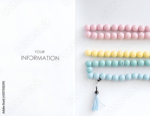 Pastel prayer beads arranged with copy space.