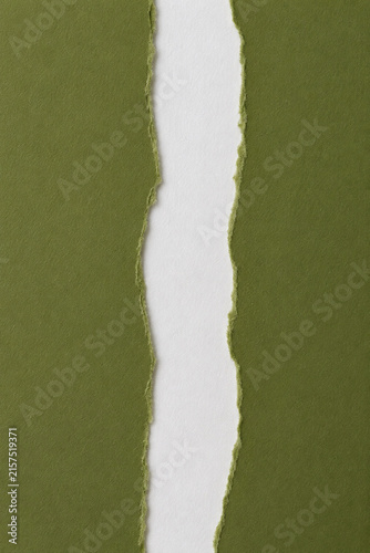 Torn olive green papers forming a white wavy gap between them