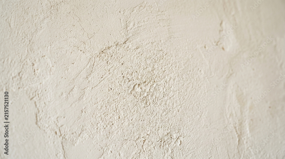 Fototapeta premium Textured plaster wall surface, beige, close-up, abstract background