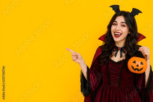 a girl pointing sideways isolated on yellow background,halloween sale concept