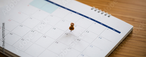 Canvas Print Close up of calendar page with thumbtacks on important dates.