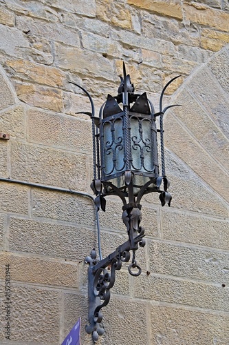 old street lantern in Florence, Italy on stone wall