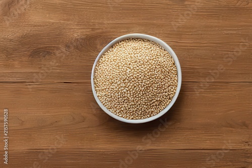 Whole grains in ceramic bowls on natural wood