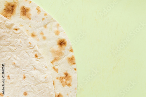 Close-up of thin pita bread texture on green cutting board related to bread, baking, food