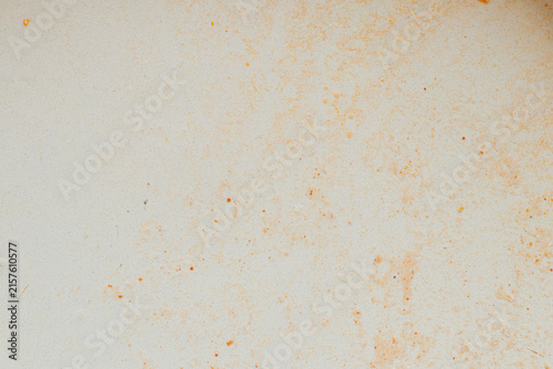 A light-colored surface with greasy stains, oil stains, and food residue, related to dirty dishes, kitchen, and dirt