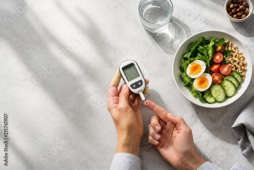 Blood Sugar Check Beside Healthy Breakfast in Morning Light